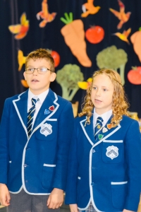 Head Boy and Head Girl at Westville House School open the schools Harvest Festival Assembly